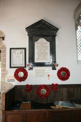 The war memorial in St James's church with poppy wreaths