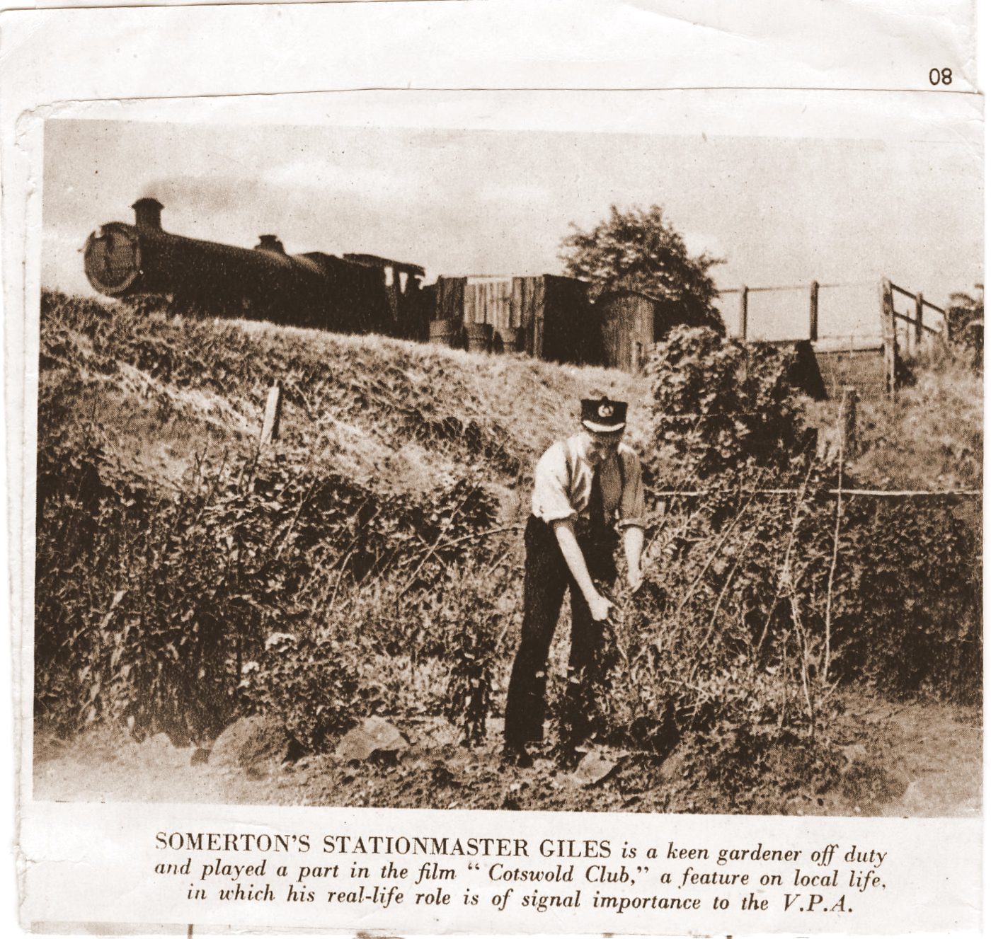 Newspaper photograph of Stationmaster Giles gardening beside the railway